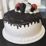 White tres leches cake with chocolate and strawberries on top